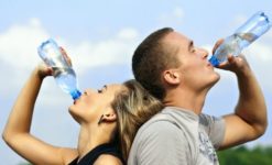 Are you dehydrated? Two people drinking water to stay hydrated