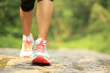 woman walking with orange and teal shoes